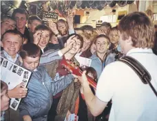  ?? ?? Anthony Meynall of Squire performing to young fans in the 1980s.