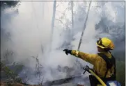  ?? MARCIO JOSE SANCHEZ — THE ASSOCIATED PRESS FILE ?? Firefighte­r Cody Nordstrom, of the North Central Fire station out of Kerman, monitors hot spots while fighting the CZU Lightning Complex Fire Aug. 23in Bonny Doon, Calif.