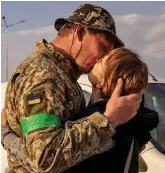  ?? ?? Kiss: Hryhorii and wife Oksana kiss after being forced apart for a year