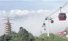  ??  ?? The Awana Skyway, which began operations last December, boasts glass floors to enhance the appeal of the rainforest and mountain views.