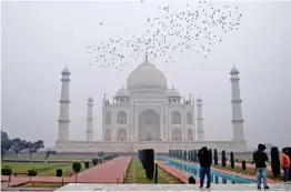  ?? — PTI ?? Birds fly over the Taj Mahal on a cold winter morning in Agra on Monday.