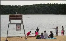  ?? PHOTO BY STEVE FAGIN ?? Beach-goers relax on shore.