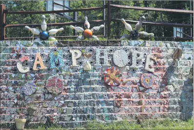  ??  ?? A colorful display saying “Camp Hope” is shown on the outdoor wall of a campground located in Schwenksvi­lle. Camp Hope for Kids connects children with nature through mentorship and outdoor activities.
