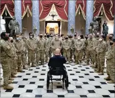  ?? Stefani Reynolds Getty Images ?? REP. BRIAN MAST (R-Fla.) gives Guard members a tour of the Capitol. The complex is now ringed by checkpoint­s and a tall fence.