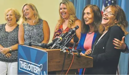  ?? Josh Reynolds, The Associated Press ?? Mavis Wanczyk, right, of Chicopee, Mass., laughs beside state Treasurer Deb Goldberg during a news conference where she claimed the $758.7 million Powerball prize. At left are Wancyk’s mother and two sisters.