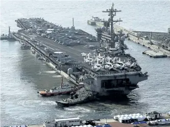  ?? JO JUNG-HO/YONHAP/AP FILES ?? U.S. Navy aircraft carrier the USS Carl Vinson is seen in this file photo. The Pentagon says a Navy carrier strike group is moving toward the western Pacific Ocean to provide a physical presence near the Korean Peninsula.