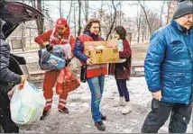  ?? Marcus Yam Los Angeles Times ?? RED CROSS workers deliver supplies in March to residents who were hiding in shelters in Kharkiv, Ukraine.