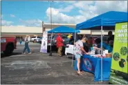  ?? TYLER RIGG — THE NEWS-HERALD ?? Visitors stop by the booths of local businesses on Aug. 24 at the Chardon Independen­t and Locally Owned Business Rally.