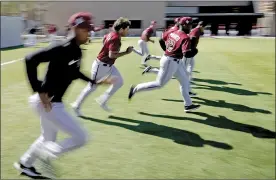  ?? AP photo ?? Arizona Diamondbac­ks players run during the first day of spring training on Friday, a day after the MLB lockout ended after the league and players agreed to a new labor deal.