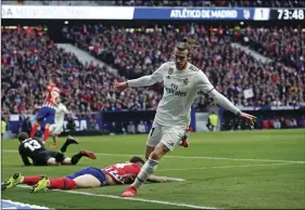  ??  ?? Real Madrid’s Gareth Bale celebrates after scoring his side’s 3rd goal during a Spanish La Liga soccer match between Atletico Madrid and Real Madrid at the Metropolit­ano stadium in Madrid, Spain, on Saturday. AP PHOTO/MANU FERNANDEZ