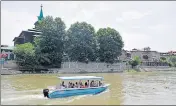  ??  ?? A motorboat, issued by the government for a trial run of waterway transporta­tion on the Jhelum, glides past the ShaheHamad­an shrine in Srinagar’s Old City. WASEEM ANDRABI/HT PHOTO