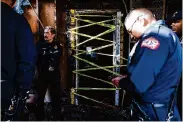  ?? ?? Oakland Fire Department members inspect the damage done to Horn Barbecue on Wednesday in Oakland. A fire on Tuesday did major damage.