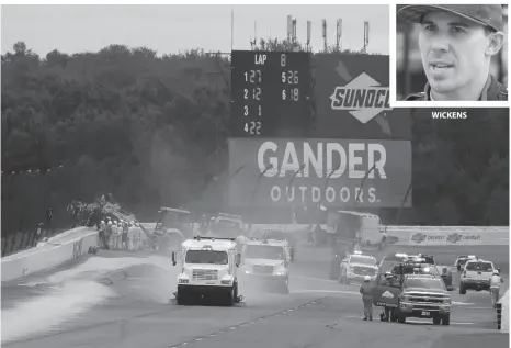  ?? AP PHOTO ?? WICKENS Track workers repair a section of fence after a wreck during the IndyCar event at Pocono Raceway on Sunday in Long Pond, Pa.