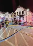  ?? Sarah Kyrcz/Hearst Conn. Media Group ?? A fire heavily damaged a historic house that served as Madison’s original post office and neighbors the E.C. Scranton Memorial Library Monday evening, according to officials.