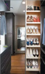  ?? THE ASSOCIATED PRESS ?? At right, this photo provided by Case Design shows a closet designed by Elena Eskandari, an interior designer specialist at Case Design. A retractabl­e shoe storage area in this closet keeps shoes organized and easily visible for the homeowner.