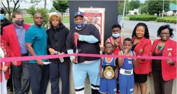  ?? (Pine Bluff Commercial/I.C. Murrell) ?? Gloves Not Guns volunteer coach Jammie Robertson (second from left); fighter Desmond Robertson; Gloves Not Guns founder and director Albert Brewer; fighters Darrion Brewer, 10, Dekylon White, 13, and Amere Oliver, 9, celebrate the club’s membership with the Redcoats from the Pine Bluff Regional Chamber of Commerce at the Pine Bluff Convention Center on Wednesday.