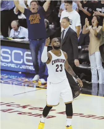 ?? AP PHOTOS ?? PUMPED UP: LeBron James raises his fist in the air to celebrate another big play by the Cavaliers star in last night’s Game 4 of the NBA Finals in Cleveland.