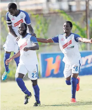  ??  ?? Reno striker Craig Foster (right) celebrates with teammates after scoring a goal against Waterhouse in a Red Stripe Premier League match at the Waterhouse Stadium last season.
