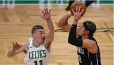  ??  ?? HANDS UP: Payton Pritchard defends Orlando’s Aaron Gordon during the first quarter.