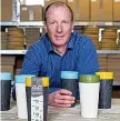  ??  ?? Dan Dicker and his recycled, leakproof, reusable coffee cups