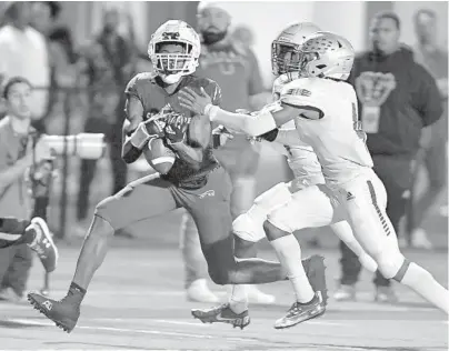  ?? MICHAEL LAUGHLIN/SOUTH FLORIDA SUN SENTINEL ?? Chaminade-Madonna receiver Jeremiah Smith catches one of many long passes against the FSU High defense during the second half of their game Friday.