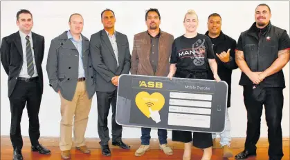  ?? PICTURE / DEBBIE BEADLE ?? Jason Witehira (centre) with Kaikohe ASB branch manager Shaun Curtis (left), Nga¯ puhi Asset Holding Company CEO Paul Knight, ASB Kaitaia branch manager James Phillips, Megan Hepi (Man-Up/Legacy), Cheyne Hakaraia (Man-Up) and Le Jorn Morunga (Kaikohe New World) with a very welcome cheque.