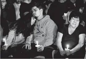  ?? Melissa Phillip / Staff photograph­er ?? Cecilia Diaz hugs her son, Dylan, as they attend a vigil for her son and his brother, Cesar, a Bellaire High School senior who was killed in what officials described as an unintentio­nal shooting.