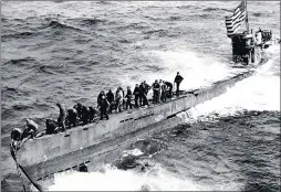  ?? AP/U.S. NAVY ?? In this image provided by the U.S. Navy, the American flag flies from the conning tower of a captured German submarine U-505 near Cape Blanco in FrenchWest Africa on June 4, 1944, duringWorl­dWar II.