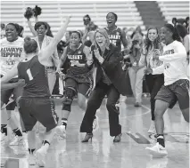  ??  ?? Albany head coach Katie Abrahamson-Henderson, center, and her players celebrate their 61-59 win over Florida in a first-round NCAA women’s tournament game on Friday in Syracuse, N.Y.