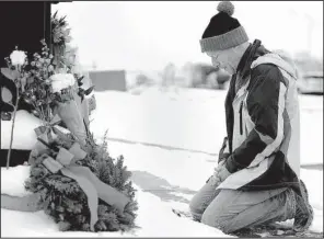  ?? AP/The Gazette/DANIEL OWEN ?? Roy Kieffer lays flowersSat­urday in honor of the victims of Friday’s shooting in Colorado Springs.