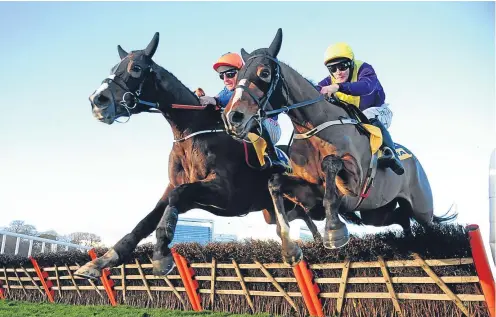  ??  ?? Mick Jazz and Davy Russell, left, go on to win the Ryanair Hurdle yesterday. Picture: PA.