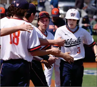  ?? PHOTO BY MARK STOCKWELL — BOSTON HERALD ?? Wapole catcher Ryan Walsh (3) high-fives his teammates after scoring on an RBI during a high school baseball game against Xaverian High in Westwood Monday.