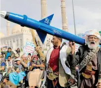  ?? AFP PHOTO ?? ROCKET TO THEM
A demonstrat­or carries a mock rocket during a rally in Yemen’s Houthi-run capital Sanaa on Friday, March 8, 2024, in support of Palestinia­ns amid the Israel-Hamas war.