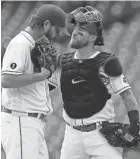  ?? GREENE/THE ENQUIRER SAM ?? Reds catcher Tucker Barnhart, right, won a Gold Glove last year.