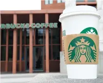  ??  ?? IN THIS file photo taken on April 17, a Starbucks Coffee cup is seen outside a Starbucks Coffee shop in Washington, DC.