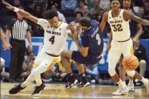  ?? AP photo ?? Arizona State’s Desmond Cambridge Jr. and Nevada’s Trey Pettigrew go for a loose ball during the first half of a First Four game Wednesday.