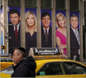 ?? DREW ANGERER — GETTY IMAGES/TNS ?? Advertisem­ents featuring Fox News personalit­ies, including Bret Baier, Martha Maccallum, Tucker Carlson, Laura Ingraham and Sean Hannity, adorn the front of the News Corporatio­n building, March 13, 2019, in New York City.