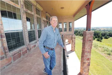  ?? [PHOTO BY PAUL HELLSTERN, THE OKLAHOMAN] ?? Kurt Swanson looks over the view from his home built by Insulated Concrete Forms & More at Meridian, 12 miles east of Guthrie.