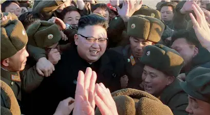  ?? AFP ?? North Korean leader Kim Jong-Un, surrounded by soldiers of the Korean People’s Army, as he inspects the test-launch of a surface-tosurface medium long-range ballistic missile Pukguksong-2 at an undisclose­d location. —