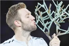  ??  ?? USA’s Jack Sock kisses the trophy after winning against Serbia’s Filip Krajinovic during the final of the ATP World Tour Masters 1000 indoor tennis tournament on November 5, 2017 in Paris. Sock won the match 5-7, 6-4 and 6-1. - AFP photo