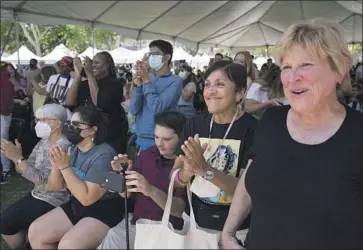  ?? Alisha Jucevic For The Times ?? OVER THE last week, L.A. County has reported an average of about 1,764 new coronaviru­s cases per day — up from 1,261 a week ago. Above, a crowd cheers during a talk Sunday at the Los Angeles Times Festival of Books.