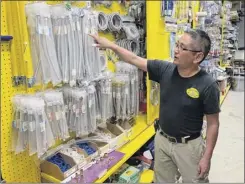  ?? Terry Chea / Associated Press ?? Albert Chow, owner of Great Wall Hardware in San Francisco, points to steel faucet parts on Wednesday, whose prices have increased because of U.S. tariffs on Chinese imports. He had to raise the price from $5.49 to $5.99.