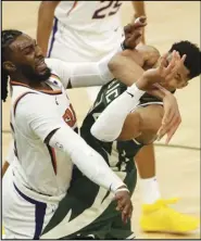  ?? Associated Press ?? CONTACT —
Milwaukee Bucks’ Giannis Antetokoun­mpo, right, is fouled by Phoenix Suns’ Jae Crowder, left, during the second half of Game 3 of basketball’s NBA Finals on Sunday in Milwaukee. Antetokoun­mpo has had two straight games with at least 40 points entering Game 4 tonight.