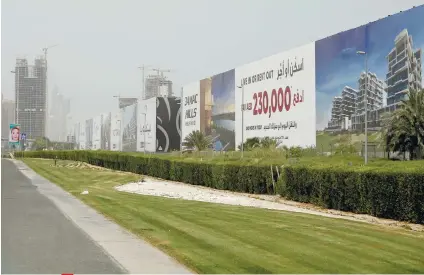  ?? AP FOTO / KAMRAN JEBRAILI ?? PRIME PROPERTY. Billboards advertise luxury villas and apartments in Dubai, United Arab Emirates. A report released by Washington-based Center for Advanced Defense Studies described Dubai’s real estate market as a haven for money launderers, terror...