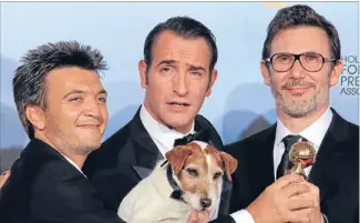  ?? Photo: REUTERS ?? Winners: The Artist producer Thomas Langmann, left, actor Jean Dujardin and director Michel Hazanavici­us pose backstage with Uggie the dog.