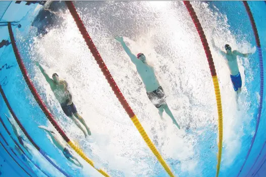  ?? STEFAN WERMUTH/REUTERS ?? In the pool at the Tokyo Olympics: from left, U.S. gold medallist Caeleb Dressel with Kliment Kolesnikov (Russia) and Alessandro Miressi (Italy).