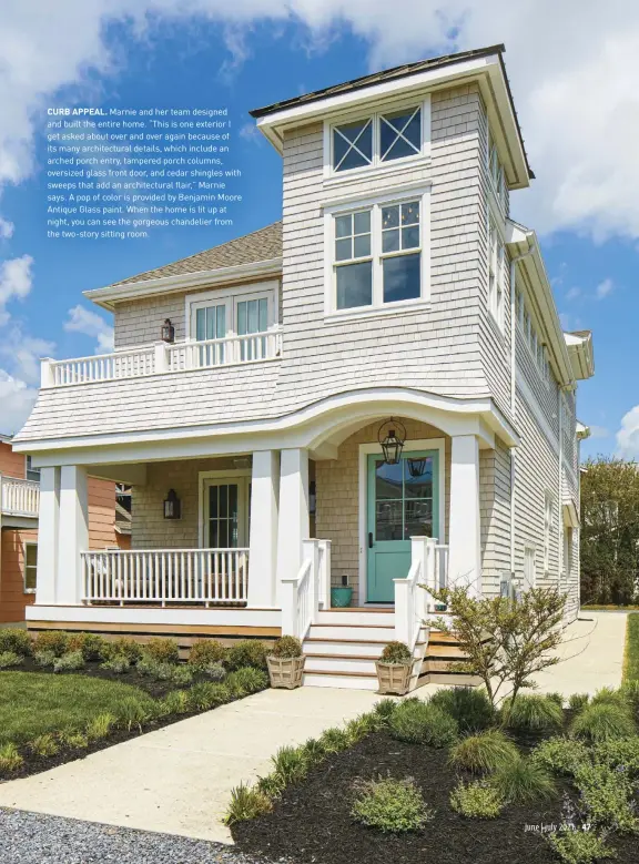  ??  ?? CURB APPEAL. Marnie and her team designed and built the entire home. “This is one exterior I get asked about over and over again because of its many architectu­ral details, which include an arched porch entry, tampered porch columns, oversized glass front door, and cedar shingles with sweeps that add an architectu­ral flair,” Marnie says. A pop of color is provided by Benjamin Moore Antique Glass paint. When the home is lit up at night, you can see the gorgeous chandelier from the two-story sitting room.