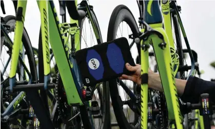  ?? Competitio­ns’. Photograph: Jeff Pachoud/AFP/Getty Images ?? A UCI official carrying out a bike inspection. The UCI said it had ‘a duty to guarantee equal opportunit­ies for all competitor­s in cycling