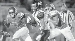  ?? MICHAEL LAUGHLIN/SUN SENTINEL ?? Palm Beach Lakes’ Antwoine Anderson sprints past McArthur’s Jarrod Barber and Rashad McMiller during their game on Nov. 9. The Rams face Dwyer on Friday.