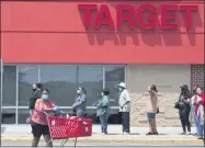  ?? MICHAEL DWYER—ASSOCIATED PRESS ?? In this Saturday, May 30, 2020, file photo, people in protective masks line up to enter a Target, in Boston, amid the coronaviru­s pandemic.